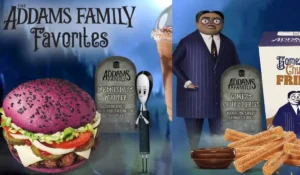 "Burger King’s purple Whopper offered as part of their limited-time Addams Family collaboration. The BOGO deal is available for rewards members on October 17, featuring a traditional Whopper served on a purple bun, along with themed menu items like churro fries, onion rings, and chocolate shakes. This spooky promotion celebrates Halloween with a unique twist."