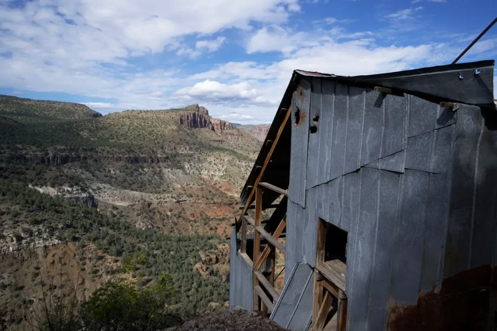 Abandoned historic buildings on a steep hillside in Jerome, Arizona ghost town with scenic desert mountain views and old mining structures