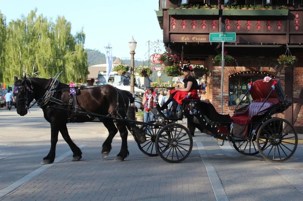 Leavenworth WA in summer with Bavarian-style buildings, mountain views, and the Wenatchee River.